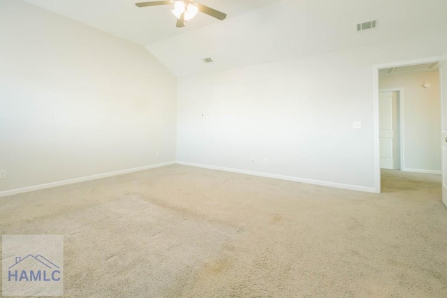 carpeted spare room featuring ceiling fan and lofted ceiling