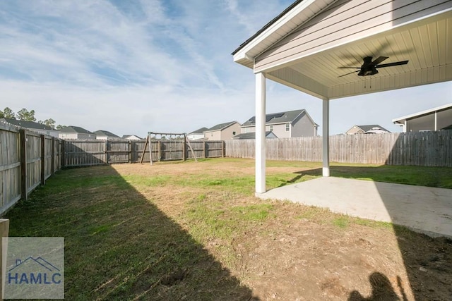 view of yard with ceiling fan and a patio