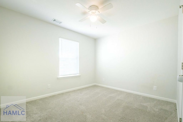 spare room featuring ceiling fan and light colored carpet