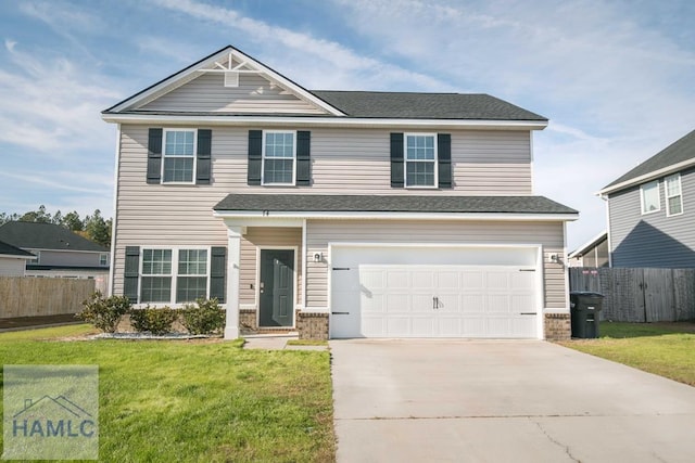 view of front of house with a garage and a front yard