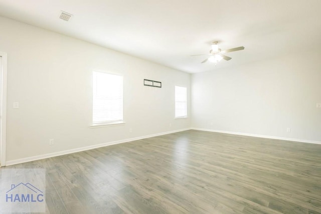 spare room featuring dark hardwood / wood-style flooring and ceiling fan