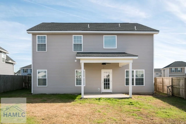 back of house with a patio area, ceiling fan, and a yard