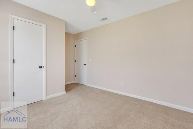 unfurnished bedroom with light carpet and ceiling fan