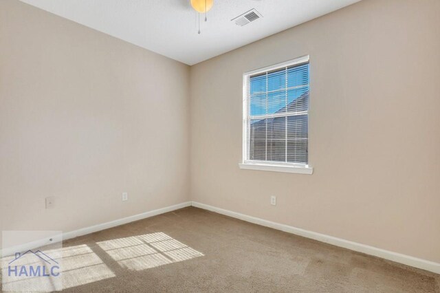 spare room with carpet floors and ceiling fan