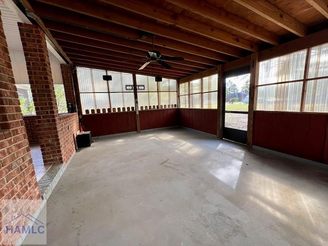 unfurnished sunroom featuring ceiling fan