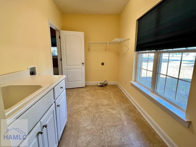 laundry room featuring washer hookup, cabinets, and sink