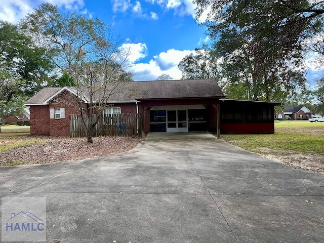 ranch-style home featuring a front yard and a carport