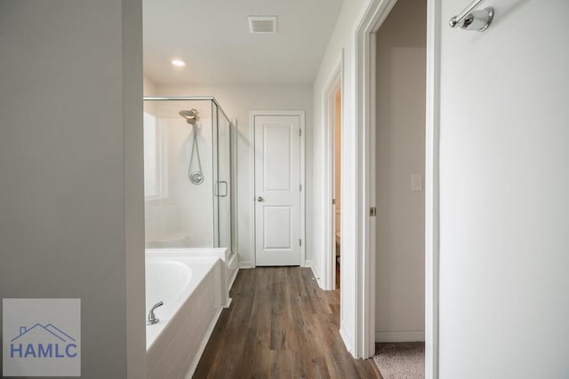 55 Enclave Way NE, Ludowici, GA 31316 - bathroom with a stall shower, a garden tub, wood finished floors, and recessed lighting