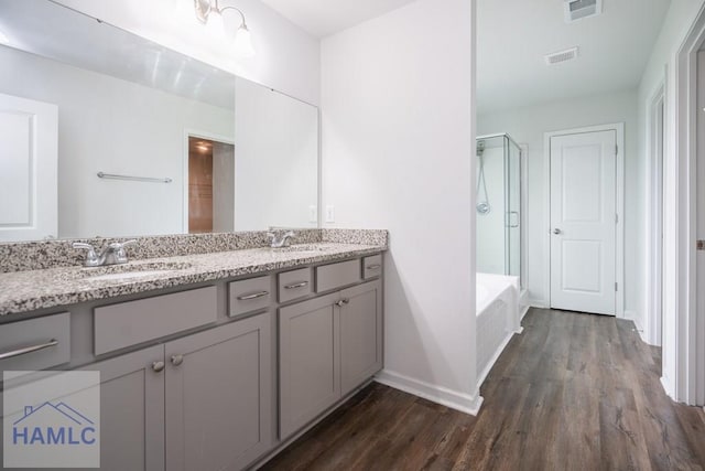 55 Enclave Way NE, Ludowici, GA 31316 - bathroom with a shower stall, wood finished floors, double vanity, and a bathtub