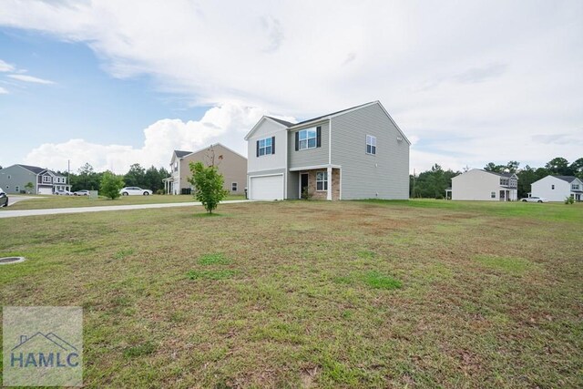 55 Enclave Way NE, Ludowici, GA 31316 - view of front facade with an attached garage, driveway, and a front lawn