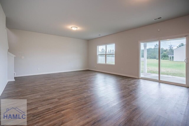 55 Enclave Way NE, Ludowici, GA 31316 - unfurnished living room with dark wood-style flooring and baseboards