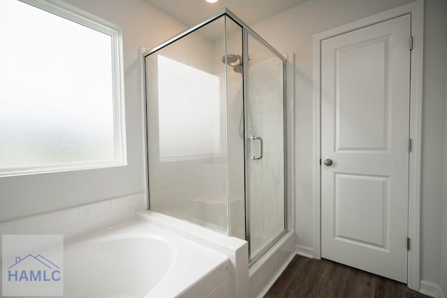 55 Enclave Way NE, Ludowici, GA 31316 - bathroom featuring a stall shower, a bath, and wood finished floors