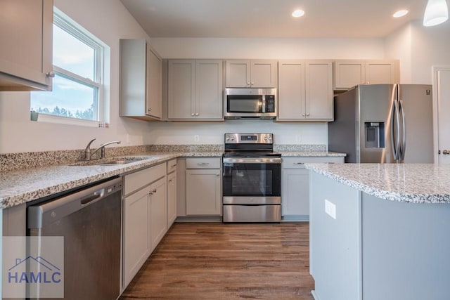 55 Enclave Way NE, Ludowici, GA 31316 - kitchen featuring stainless steel appliances, dark wood finished floors, recessed lighting, light stone counters, and gray cabinetry