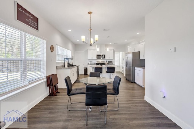 dining area with a chandelier, recessed lighting, baseboards, and dark wood-style flooring