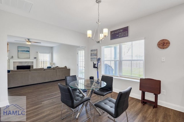 dining area with plenty of natural light, a fireplace, and dark wood-style flooring