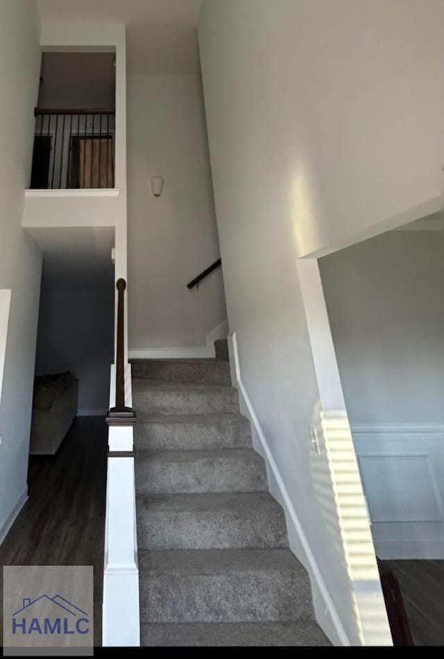 stairway featuring baseboards and wood finished floors