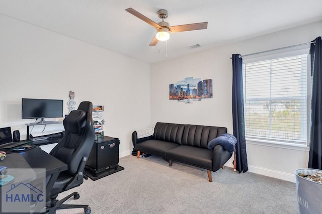 home office with visible vents, carpet floors, baseboards, and a ceiling fan