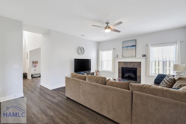 living room featuring baseboards, a fireplace, dark wood finished floors, and a ceiling fan