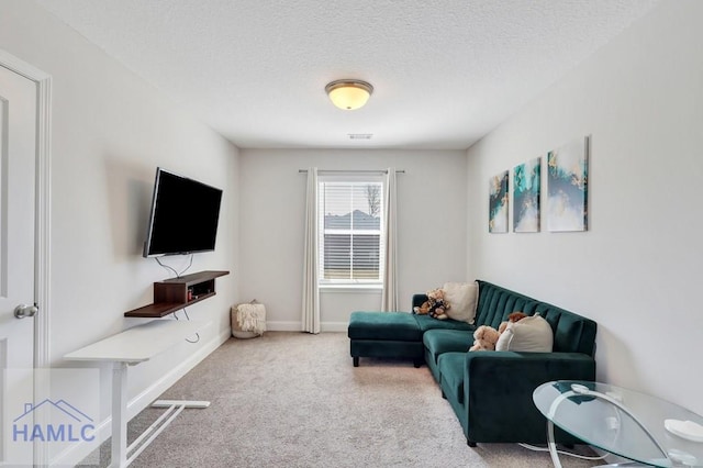 carpeted living room with a textured ceiling and baseboards