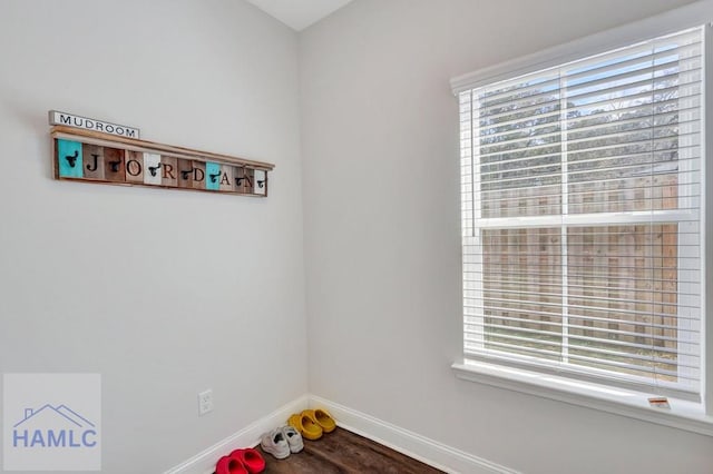 interior space featuring baseboards and wood finished floors