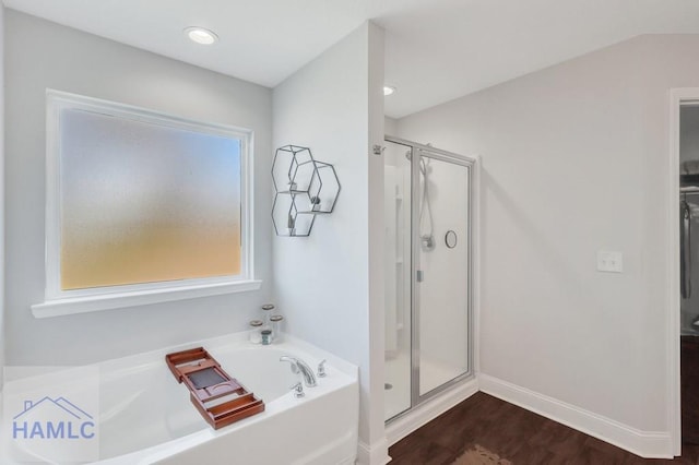 full bath featuring a bath, plenty of natural light, and a shower stall