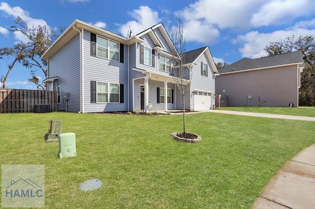 view of front of property with concrete driveway, a garage, fence, and a front yard