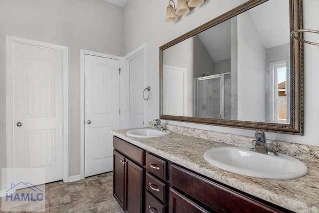 bathroom featuring vanity and a shower with door