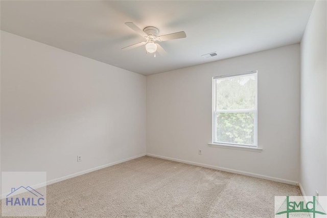 unfurnished room featuring light carpet, a ceiling fan, and baseboards