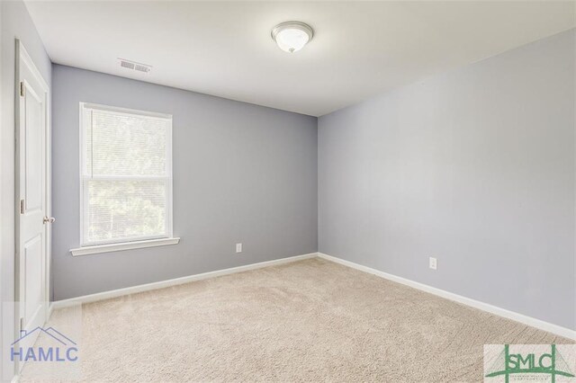 carpeted spare room with baseboards