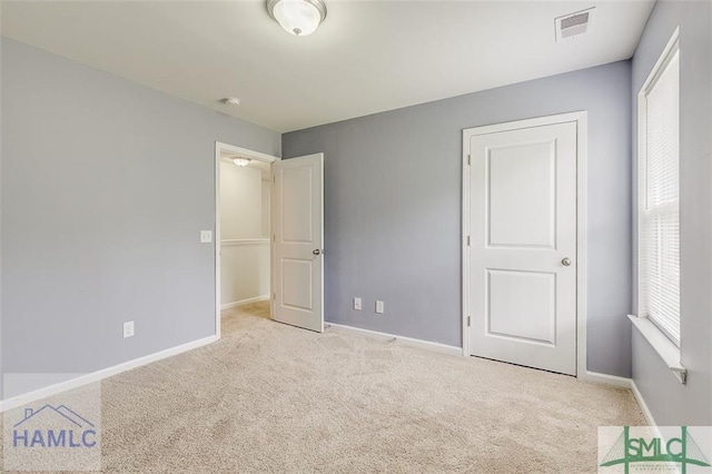 unfurnished bedroom featuring carpet and baseboards