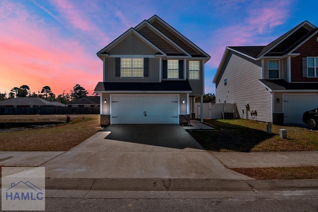 craftsman house featuring concrete driveway, an attached garage, fence, central air condition unit, and board and batten siding