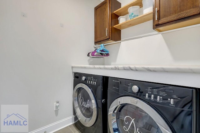 laundry area with cabinet space, baseboards, washing machine and dryer, and tile patterned flooring