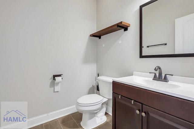 bathroom featuring toilet, baseboards, tile patterned floors, and vanity