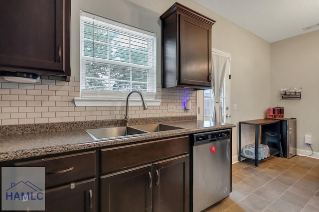 kitchen with dark brown cabinetry, visible vents, tasteful backsplash, dishwasher, and a sink