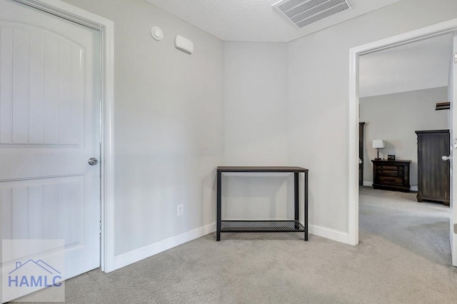 interior space with carpet floors, baseboards, and visible vents