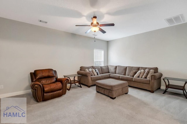living room featuring light carpet, a ceiling fan, and visible vents