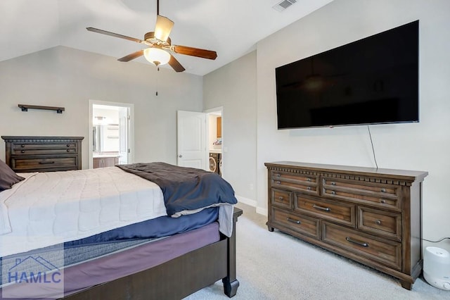 bedroom with visible vents, light carpet, ensuite bathroom, ceiling fan, and vaulted ceiling