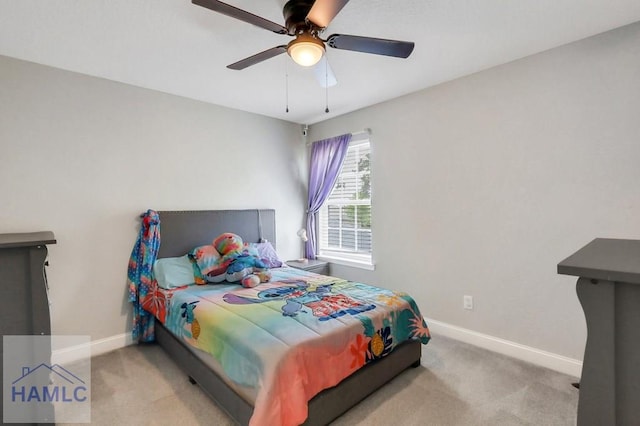 carpeted bedroom featuring baseboards and a ceiling fan