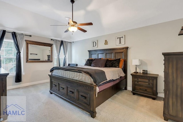 bedroom with a ceiling fan, baseboards, and light colored carpet