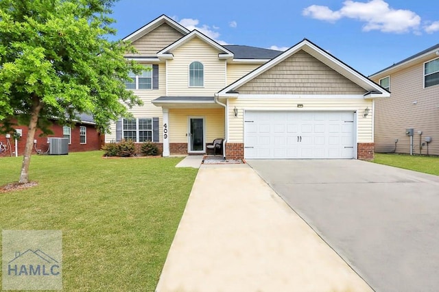 view of front of house featuring brick siding, driveway, a front yard, and a garage