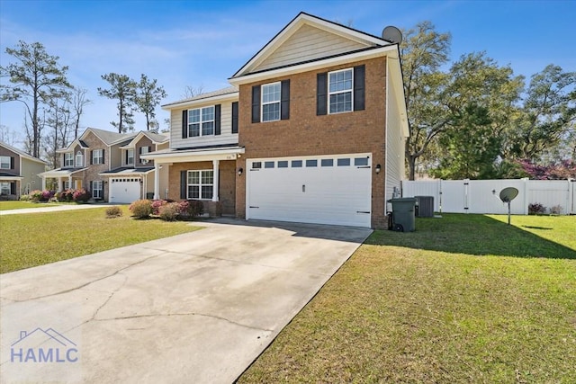 traditional-style home featuring brick siding, fence, a front yard, driveway, and an attached garage