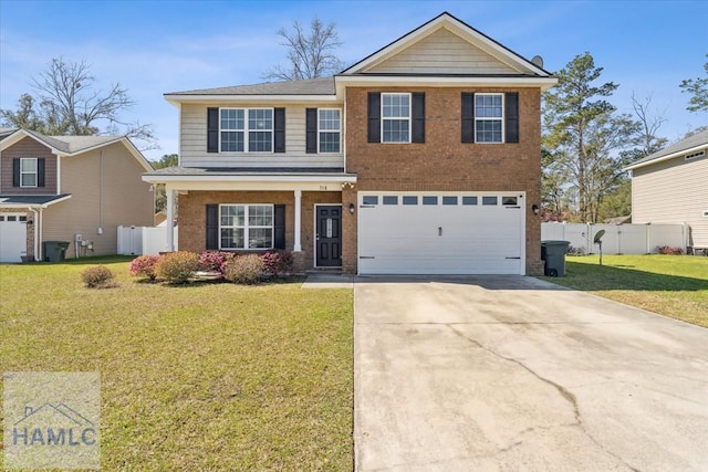 traditional-style house with brick siding, an attached garage, fence, a front yard, and driveway