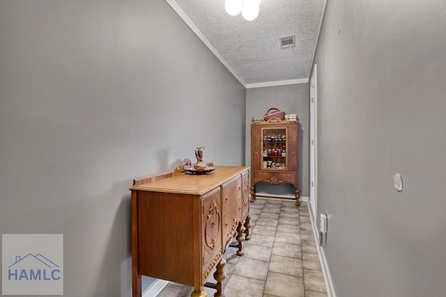 corridor featuring ornamental molding and a textured ceiling