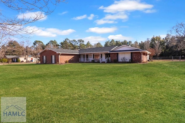 single story home with a front yard and covered porch