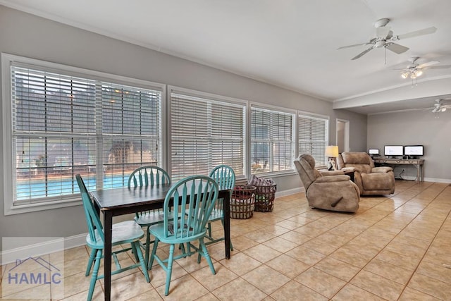 tiled dining space featuring a healthy amount of sunlight and ceiling fan