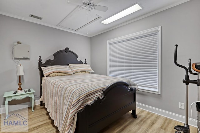 bedroom featuring ornamental molding, ceiling fan, and light wood-type flooring