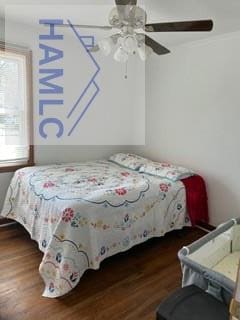 bedroom featuring crown molding, a ceiling fan, and wood finished floors