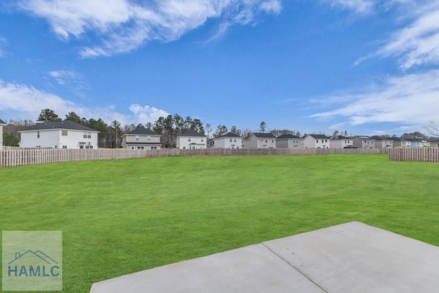 view of yard featuring a residential view and fence