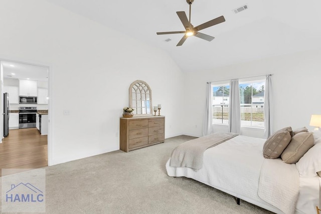 carpeted bedroom featuring high vaulted ceiling, freestanding refrigerator, visible vents, and a ceiling fan