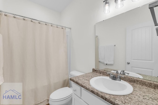 full bathroom with toilet, shower / bath combo with shower curtain, and vanity